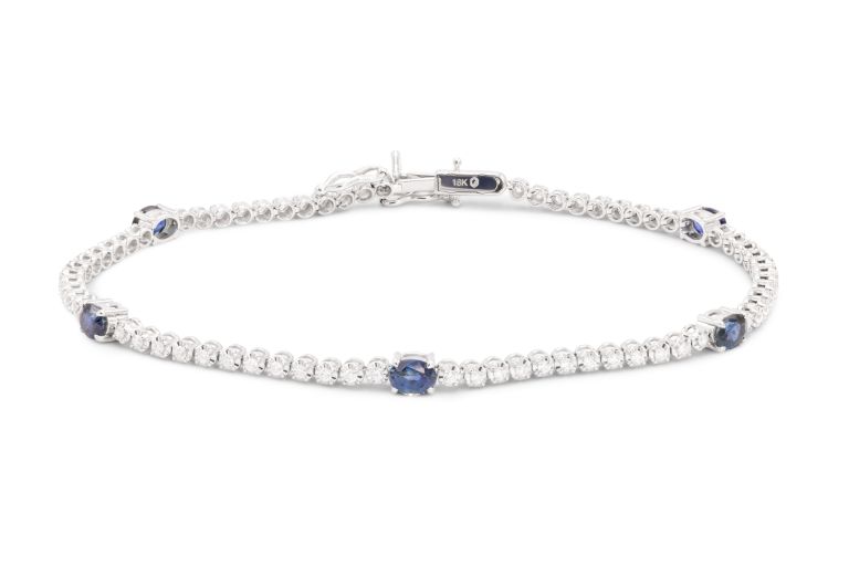 18K White Gold Sapphire and Diamond Bracelet set with 5 oval shaped blue sapphires (1.31ctw) and 71 round diamonds (0.49ctw) (FG