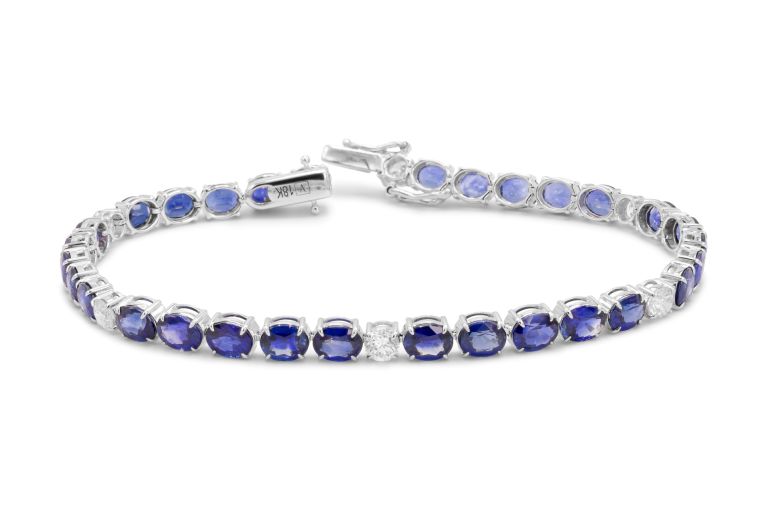 18K White Gold Sapphire and Diamond Bracelet set with 30 oval shaped sapphires (12.86ctw) and 6 round diamonds (1.02ctw) (FG